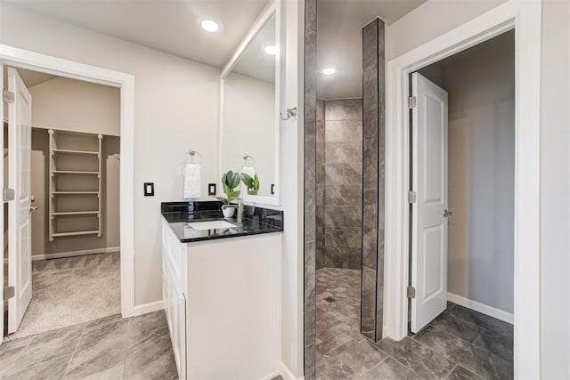 bathroom with a tile shower and sink