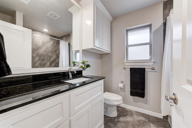 bathroom with vanity and toilet