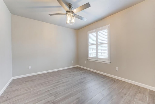 spare room featuring light hardwood / wood-style flooring and ceiling fan