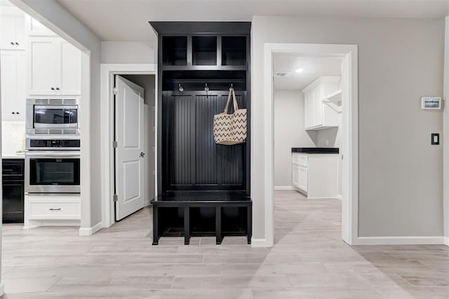 mudroom with light hardwood / wood-style flooring