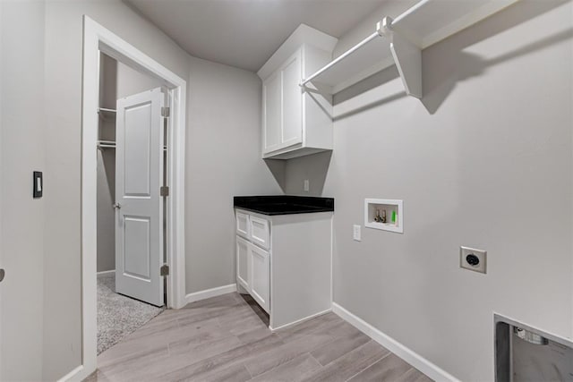 laundry room featuring cabinets, washer hookup, light hardwood / wood-style floors, and electric dryer hookup