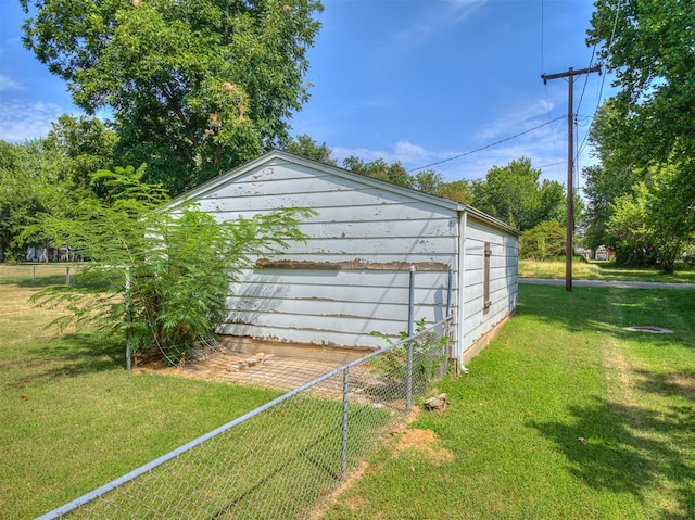 view of outdoor structure featuring a lawn