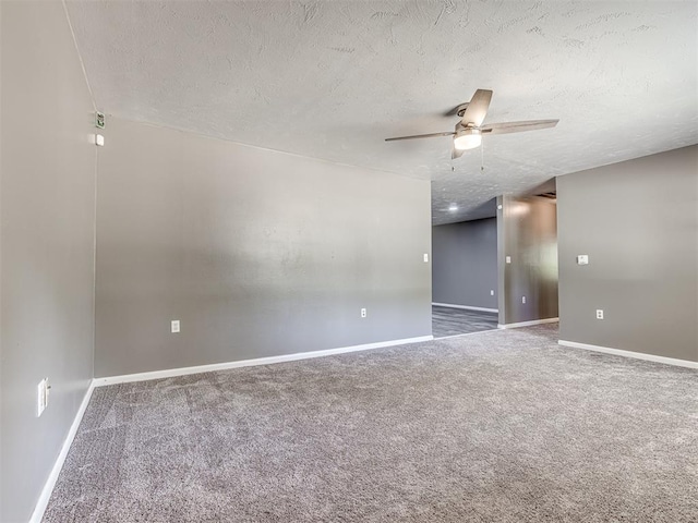 empty room with carpet flooring, ceiling fan, and a textured ceiling