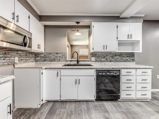 kitchen featuring light wood-type flooring, white cabinets, sink, decorative light fixtures, and dishwasher