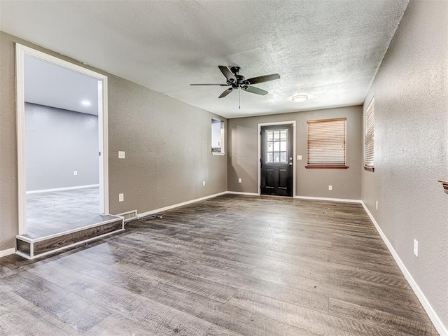 entrance foyer featuring hardwood / wood-style flooring, ceiling fan, and a textured ceiling