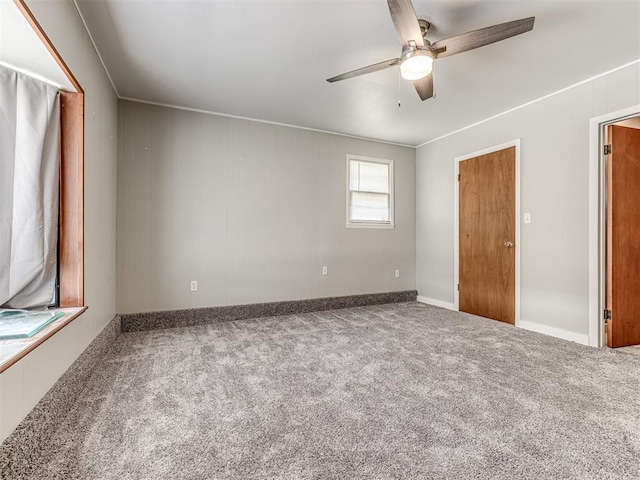 unfurnished bedroom featuring carpet, ceiling fan, and crown molding