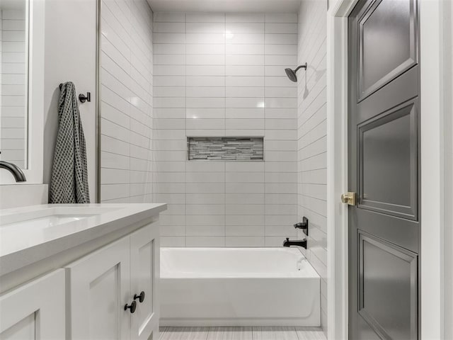 bathroom featuring vanity and tiled shower / bath combo