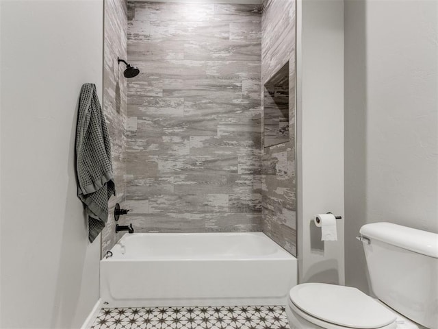 bathroom with tub / shower combination and toilet