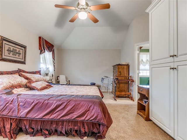 bedroom with light colored carpet, ceiling fan, and lofted ceiling