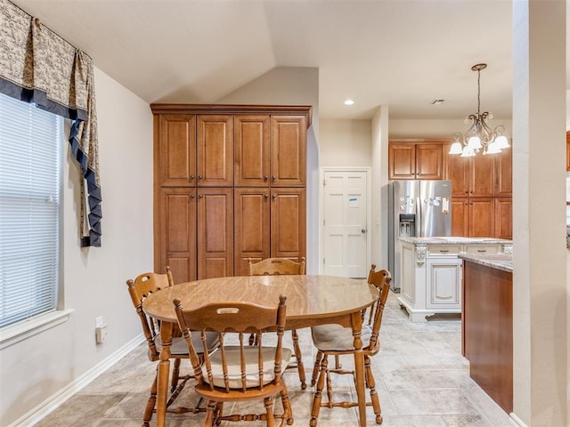 dining room featuring vaulted ceiling and a chandelier