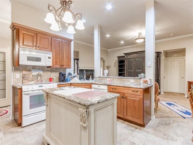 kitchen featuring kitchen peninsula, a chandelier, white appliances, and ornamental molding