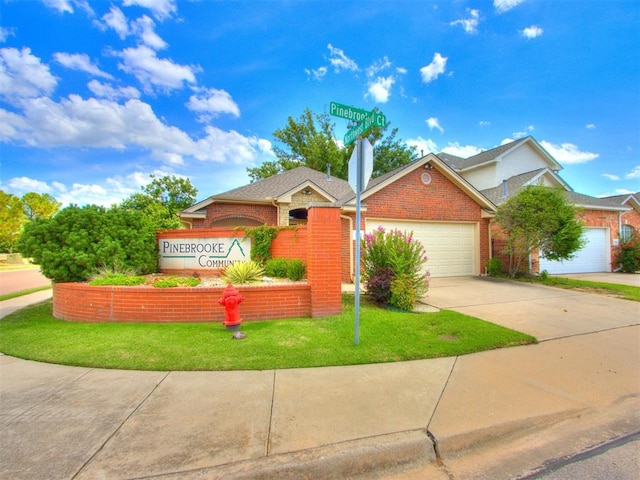 view of front of property featuring a garage and a front yard