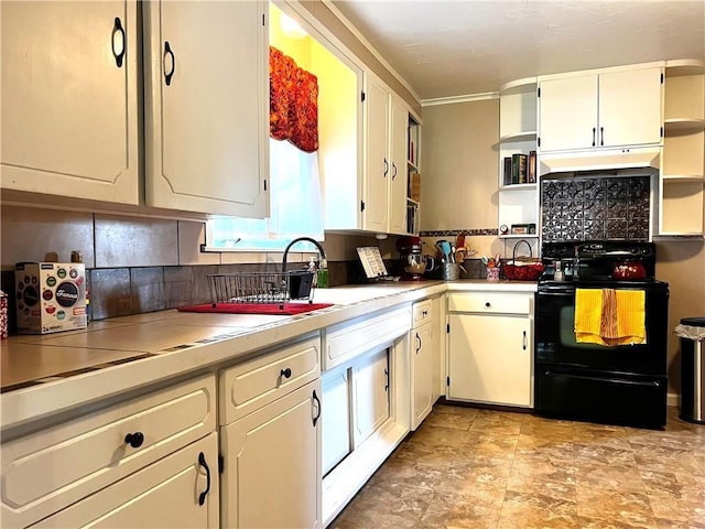 kitchen featuring white cabinetry and electric range