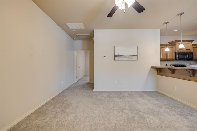 unfurnished living room with ceiling fan and light colored carpet