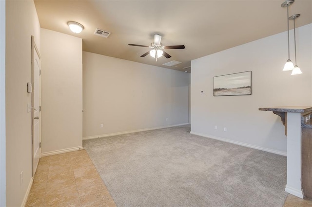 unfurnished living room featuring ceiling fan and light colored carpet