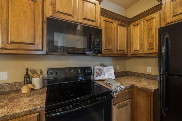 kitchen with black appliances and dark stone countertops