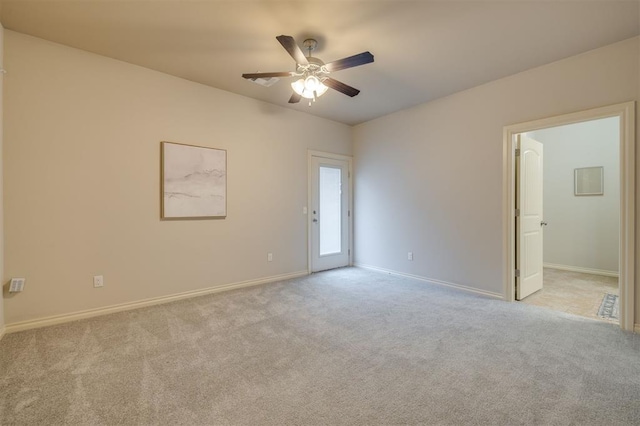 carpeted spare room with ceiling fan