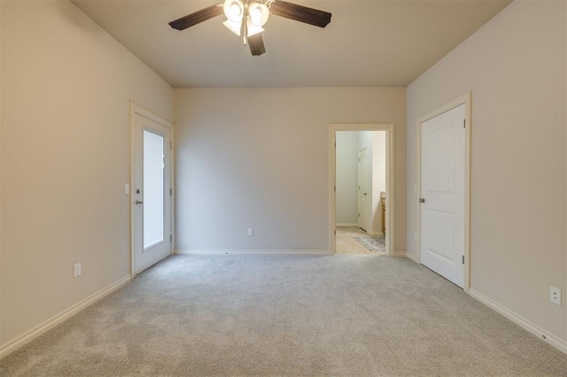 carpeted spare room featuring ceiling fan