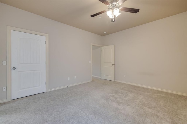 carpeted spare room with ceiling fan