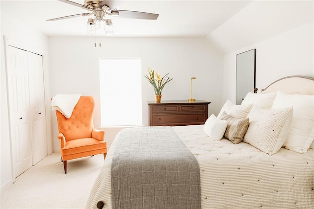 carpeted bedroom featuring ceiling fan, a closet, and lofted ceiling