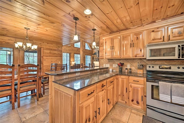 kitchen with pendant lighting, a notable chandelier, kitchen peninsula, and stainless steel stove