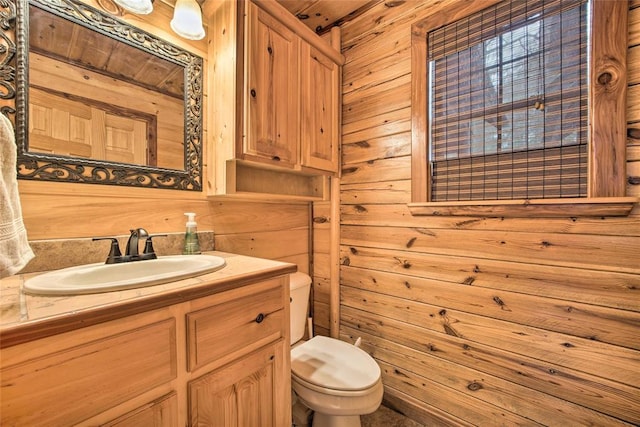 bathroom featuring vanity, toilet, wooden walls, and wood ceiling