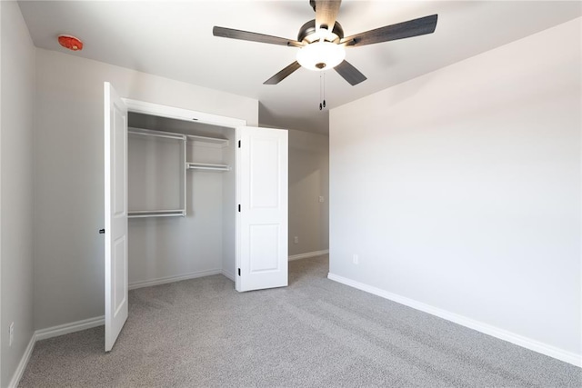 unfurnished bedroom featuring light carpet, a closet, and ceiling fan