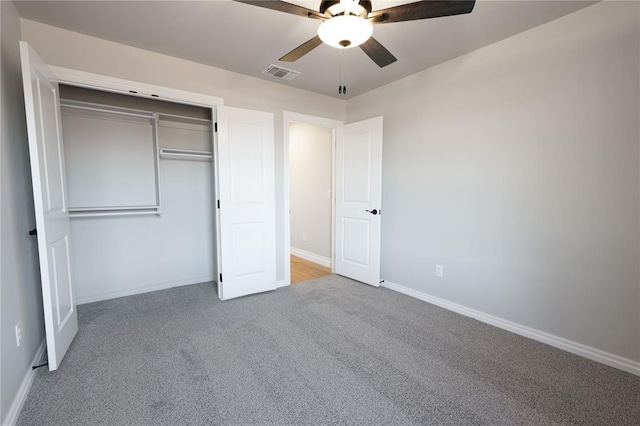 unfurnished bedroom featuring carpet flooring, ceiling fan, and a closet