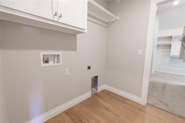 laundry area featuring washer hookup, light hardwood / wood-style flooring, cabinets, and hookup for an electric dryer