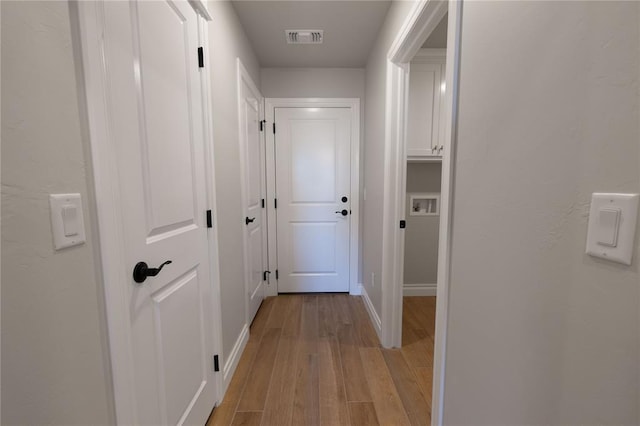 hallway with light wood-type flooring