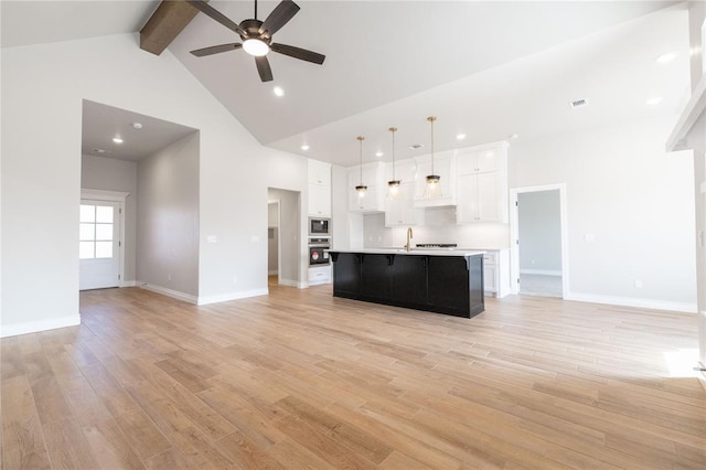 unfurnished living room with high vaulted ceiling, baseboards, beamed ceiling, light wood finished floors, and a ceiling fan