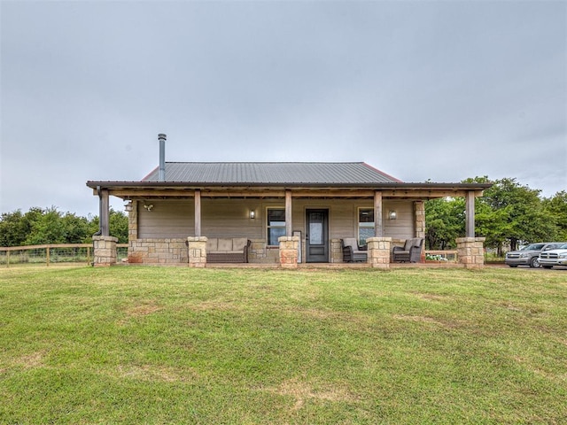 rear view of property with a porch and a yard