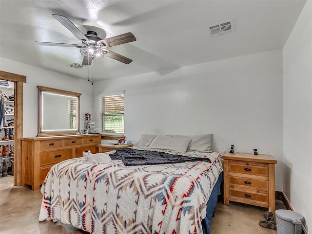 bedroom featuring a spacious closet and ceiling fan