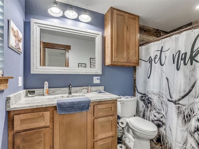 bathroom featuring a shower with curtain, vanity, and toilet