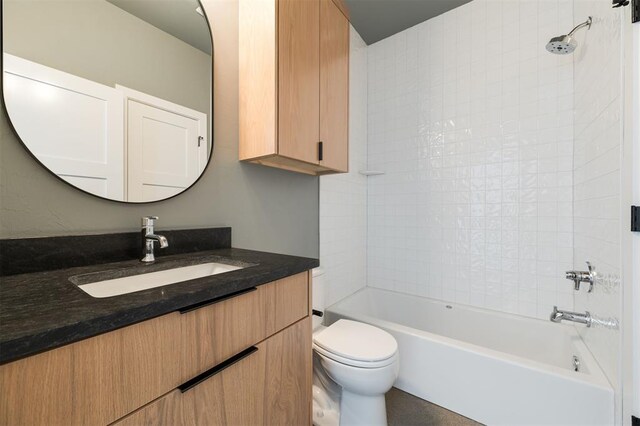 bathroom with vanity,  shower combination, and toilet