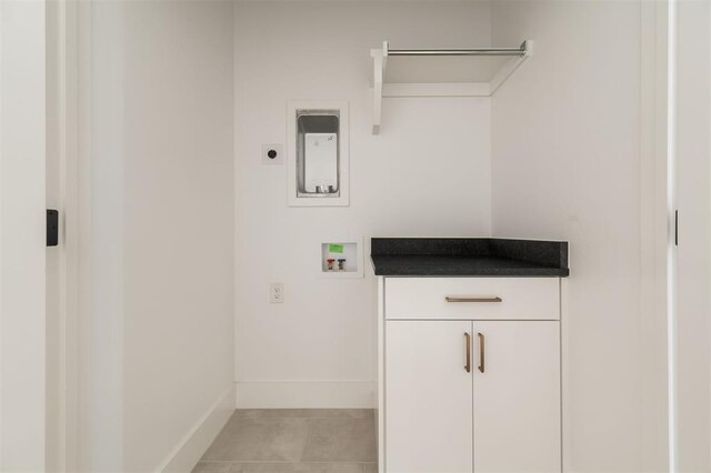 laundry area featuring baseboards, cabinet space, washer hookup, light tile patterned floors, and hookup for an electric dryer