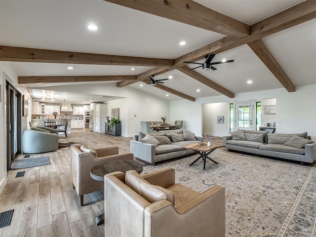 living room with lofted ceiling with beams, hardwood / wood-style flooring, and ceiling fan