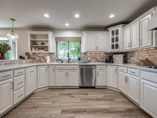 kitchen featuring light wood-type flooring, white cabinetry, and sink