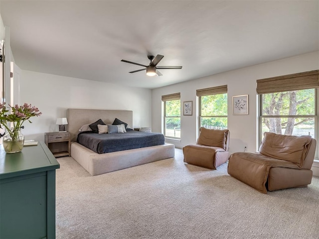 bedroom with light carpet and ceiling fan