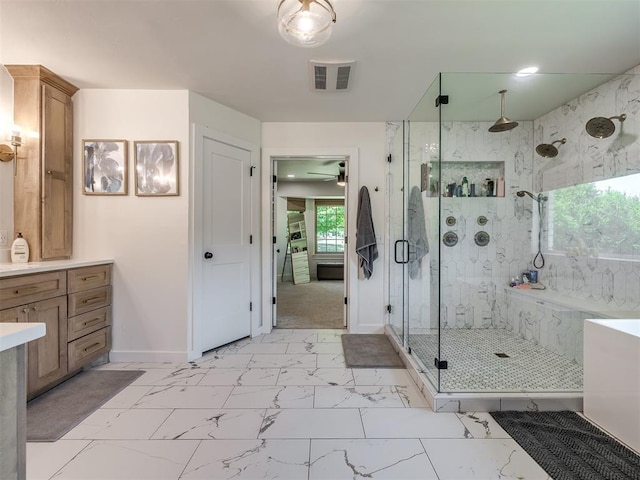 bathroom featuring vanity, a shower with shower door, and a wealth of natural light