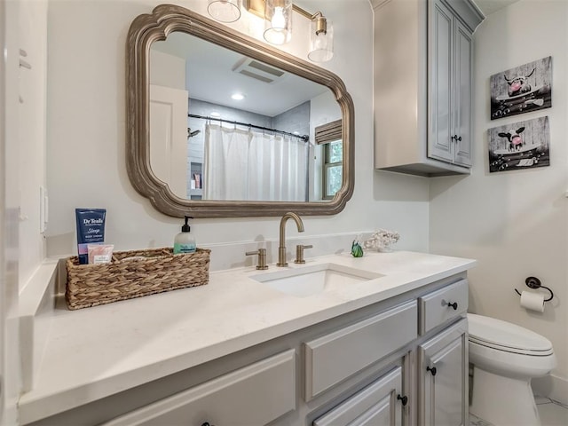 bathroom with tile patterned flooring, vanity, a shower with shower curtain, and toilet