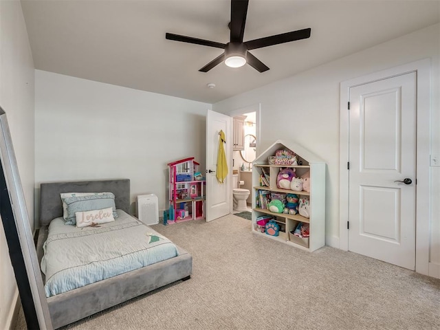 carpeted bedroom featuring ceiling fan and ensuite bathroom