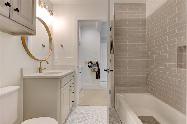 full bathroom with vanity, tiled shower / bath combo, and toilet