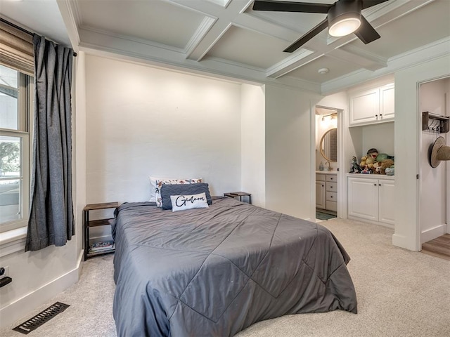 carpeted bedroom featuring ceiling fan, ornamental molding, connected bathroom, and coffered ceiling