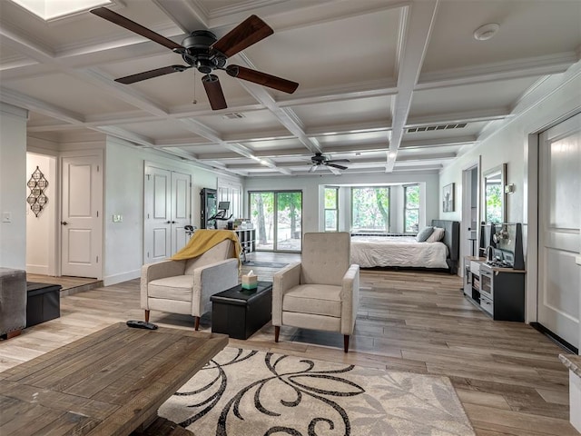 bedroom featuring coffered ceiling, crown molding, beamed ceiling, and light hardwood / wood-style flooring