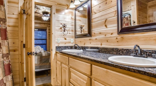 bathroom with wood walls and vanity