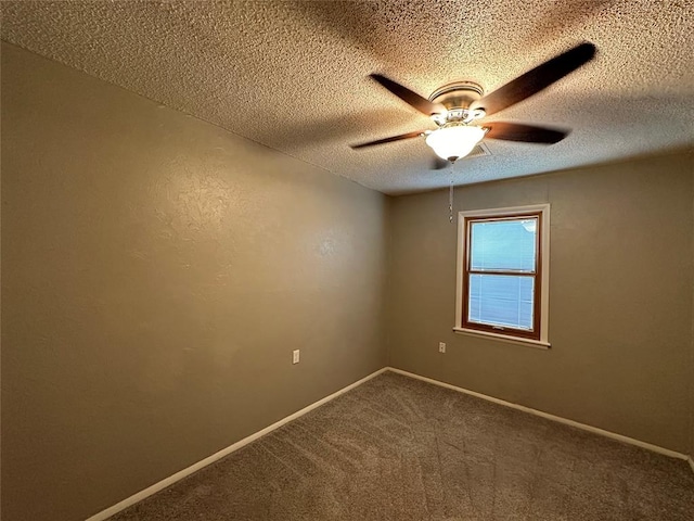 carpeted spare room featuring ceiling fan and a textured ceiling