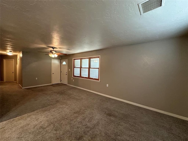 spare room with ceiling fan, carpet floors, and a textured ceiling