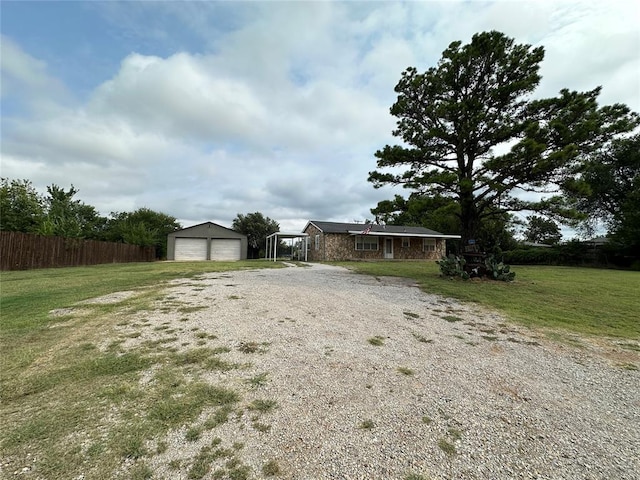 view of yard featuring a garage and an outbuilding