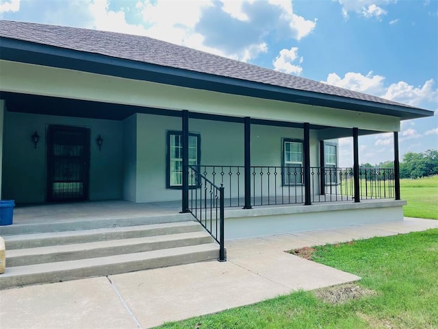 exterior space with a porch and a lawn